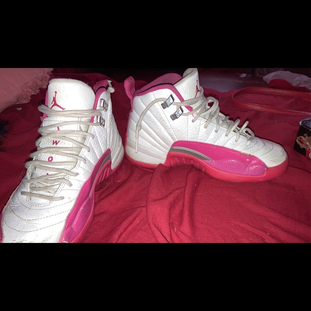 Pink and white Jordan 12s